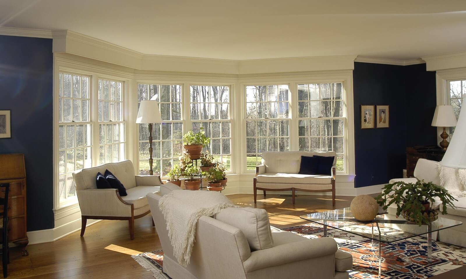 Interior view of angled bay windows of living room designed by MA architect and builder