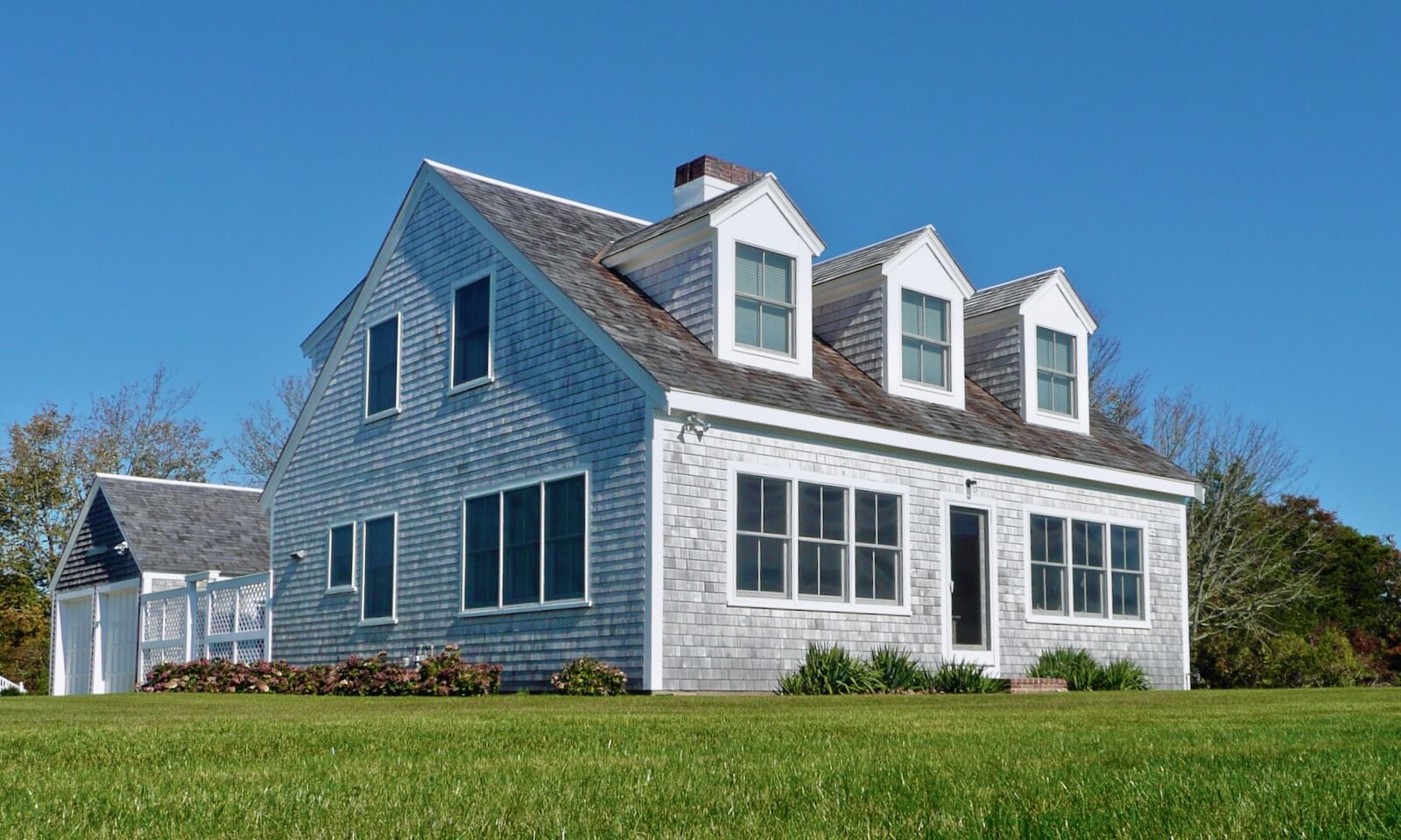 Cape Cod House with enlarged front windows to capture view of Stage Harbor, Chatham, MA