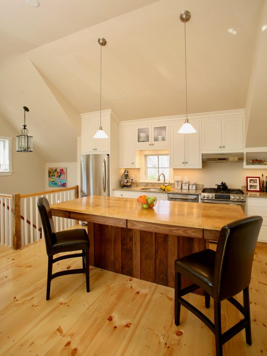 Vaulted living area with custom walnut kitchen island in converted barn in Cohasset MA