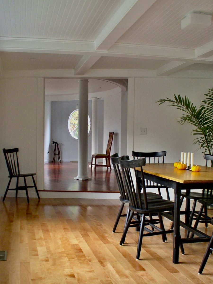 Interior view of Shingle Style house with coffered ceiling, Tuscan column and oval window, Duxbury MA