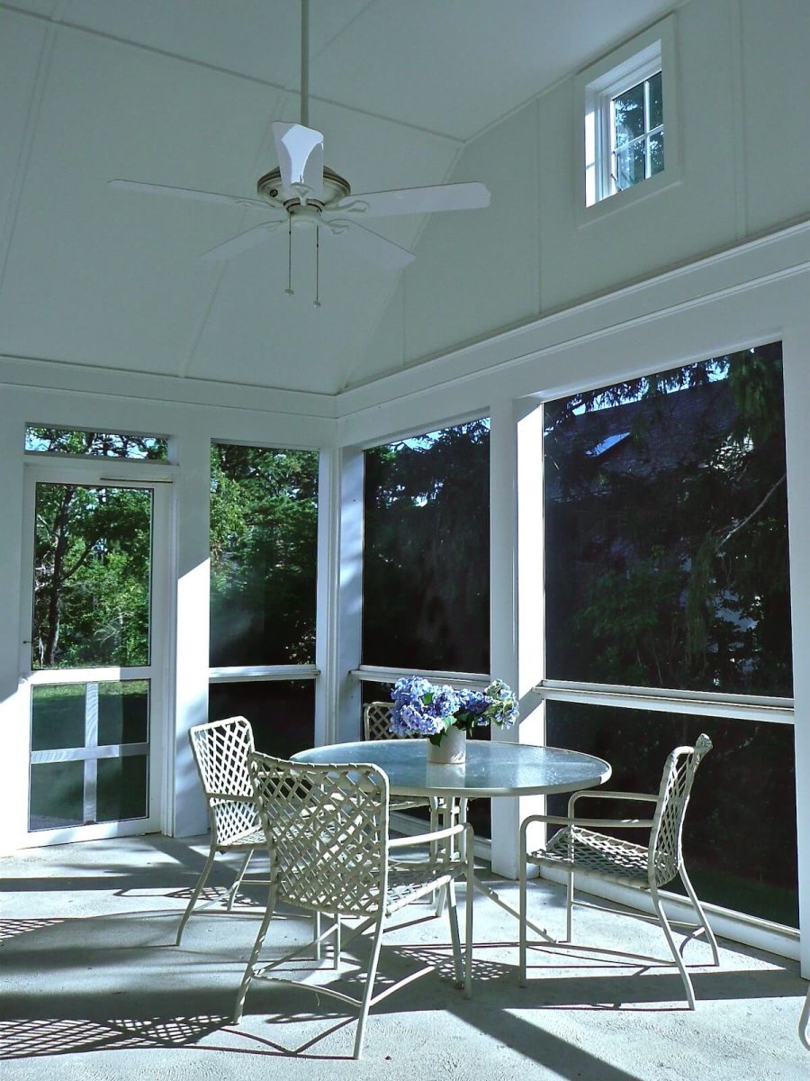 Screened porch with vaulted ceiling with fan in classic Cape house by Duxbury architect and builder